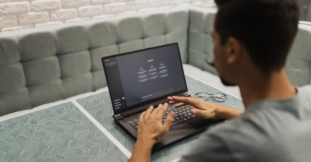 A man working on a laptop in a cozy, modern office space with a focus on technology.