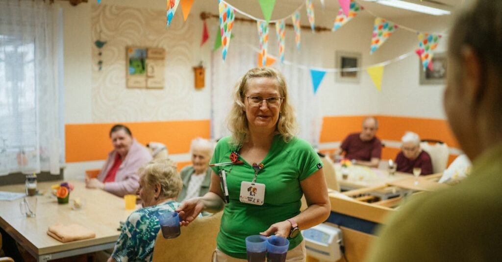 A caregiver serving drinks to elderly residents in a cheerful nursing home setting.