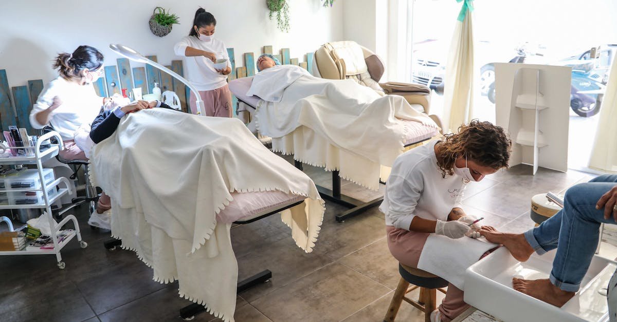 Peaceful spa scene with professionals giving facial and pedicure treatments in a well-lit salon.